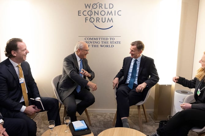 Chancellor Jeremy Hunt talks to chairman of AstraZeneca Michel Demare, at Davos 2024