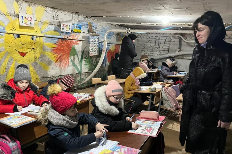 Children taking a school lesson in a shelter in Ukraine. 