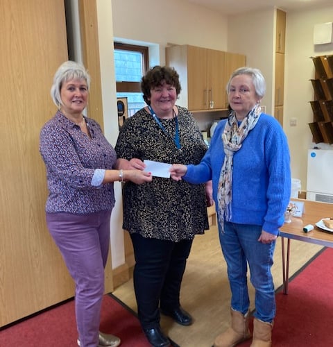 Katie Hughes of Citizens' Advice receives a cheque for £500 from Maureen Mortara and Jane Standing from the Church of St Lawrence, April 2024.
