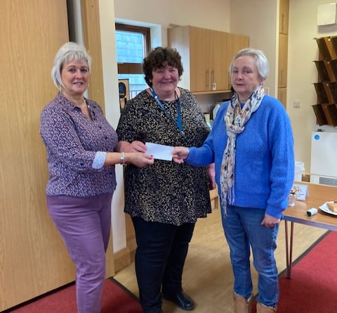 Katie Hughes of Citizens' Advice receives a cheque for £500 from Maureen Mortara and Jane Standing from the Church of St Lawrence, April 2024.