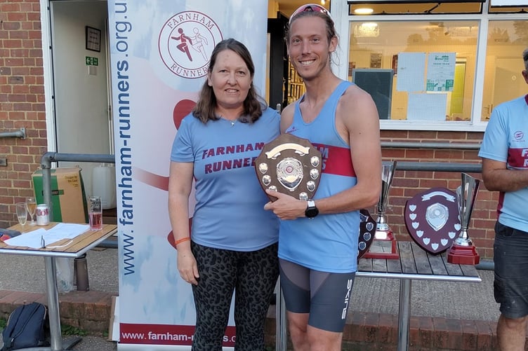 Third finisher and first M40 Chris Matthews receives his trophy from Nicola O'Connor