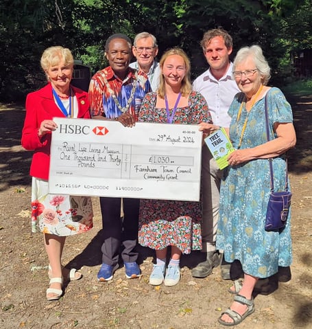 Mayor Mauluka presents the check to the museum's staff and volunteers