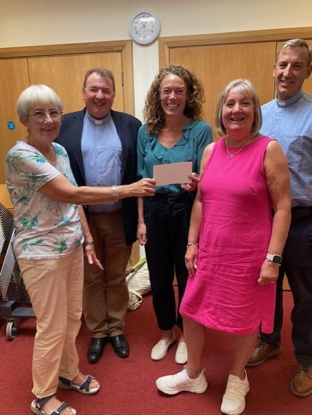 Kate Powell, centre, receives a cheque for £1,000 from Alton Methodist Church on behalf of the Anna Chaplaincy in Alton, September 2024.