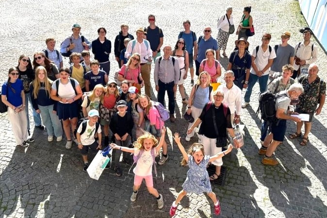 Choir and chaperones relaxing outside the Eglise de la Madeleine, Fauré’s parish church, after their final concert.