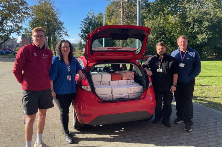 Packing Oakmoor School's shoe boxes for Alton Rotary Club's appeal for Christmas presents for Ukrainian children, from left, are head of PE David Oliver, receptionist Holly Newington, and site staff Gary Etherington and Morne De Vries. November 7th 2024.