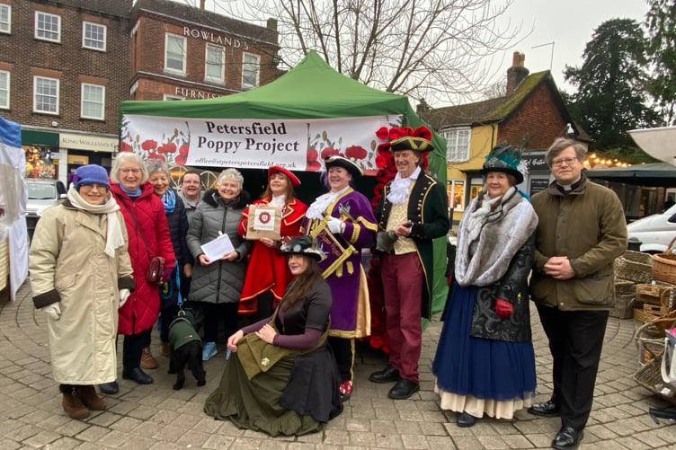 Members of the Poppy Project, town criers and supporters attend the launch at the Saturday market in Petersfield, Jan 2025