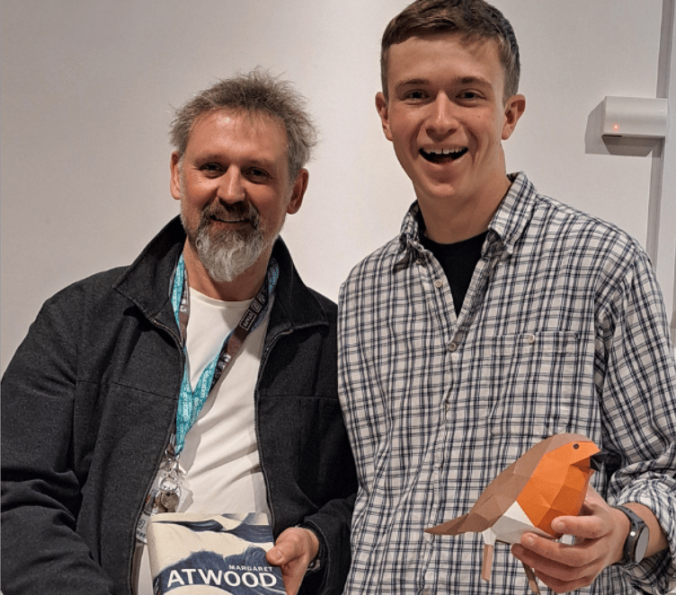 Nathan Ward, right, with Alton College art lecturer Mark Taylor. Mark is holding Paper Boat by Margaret Atwood, a poetry anthology for which Nathan designed the cover, January 2025.