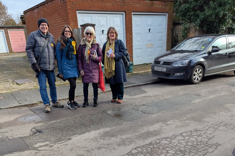 Lib-Dem pothole campaigners record the state of roads in Farnham.