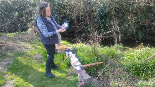 Claire Matthes collecting River Wey water samples
