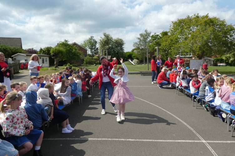 Children and staff dancing at Badshot Lea Primary School's VE Day celebrations.