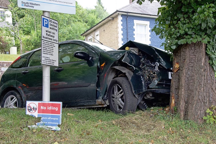 The wrecked Ford Focus after it collided with a tree outside Haslemere station