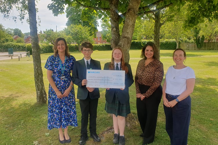 Pupils receive a cheque for £750 from PelGar International, watched by Amina Kellie, Marion Goodes and Sarah Holman, Eggar's School, Holybourne, June 17th 2025.