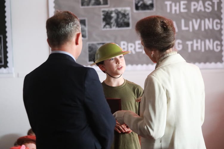 Nine-year-old Bellamy Budd receives his commemorative Canadian coin from HRH the Princess Royal at Liphook CofE School.
