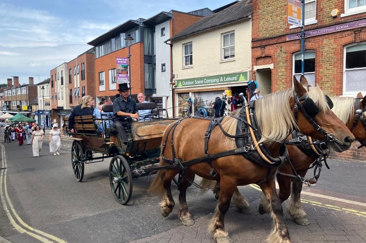 A carriage and horses lead the Regency Day procession up Alton High Street on June 21st 2025.