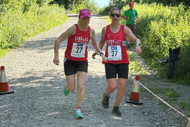 Alex Coomber takes the baton from Sandra Hunter at the start of leg 15 in Queen Elizabeth Country Park
