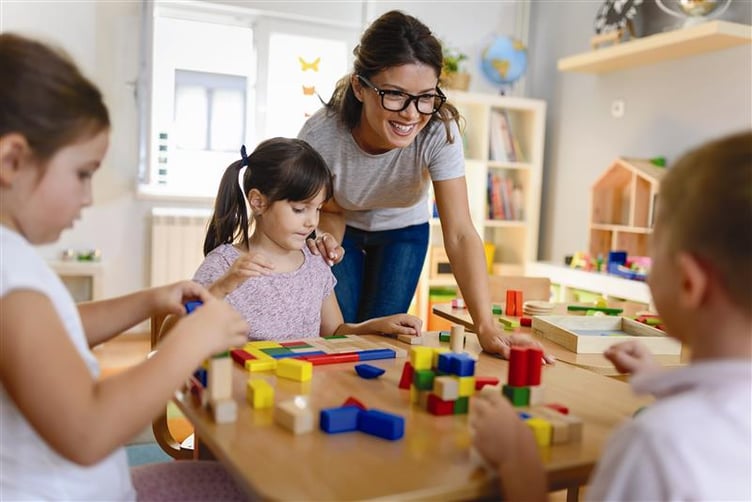Early years children playing with toy blocks.