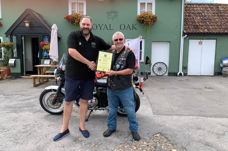 The Royal Oak's owner Barry Pethers, left, receives his VE Day 80 Anniversary Convoy Certificate of Thanks from Stephen Gough of the Hampshire Royal British Legion Branch, August 5th 2025.