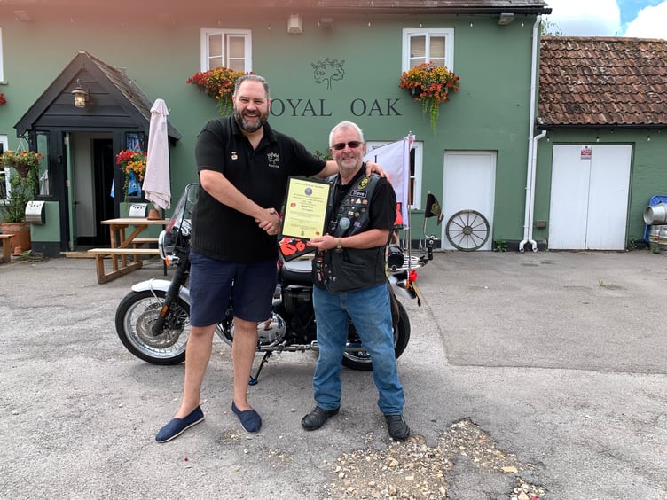 The Royal Oak's owner Barry Pethers, left, receives his VE Day 80 Anniversary Convoy Certificate of Thanks from Stephen Gough of the Hampshire Royal British Legion Branch, August 5th 2025.