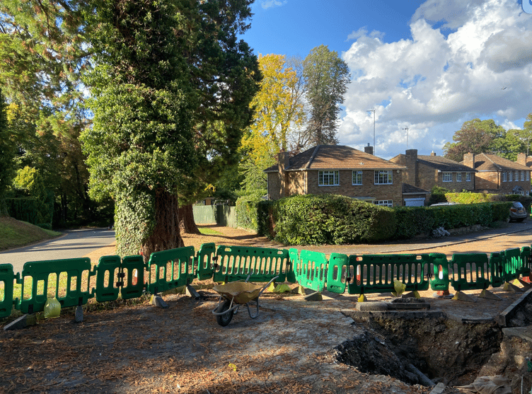 A gas main trench on the other side of the pavement from one of the Wellingtonia trees in Crowley Drive, Alton, September 8th 2025.