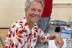 Local author Claire Davies signing copies of her book 'Braver Than You Think, Cycling to Self-Discovery, From Land’s End to John O’Groats’