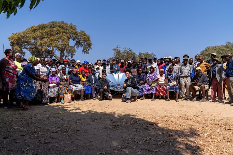Thomas Hu and his friends demonstrate their solar cooker in Zimbabwe.