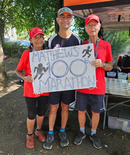 Matthew and his mum and dad celebrating his 100th Marathon