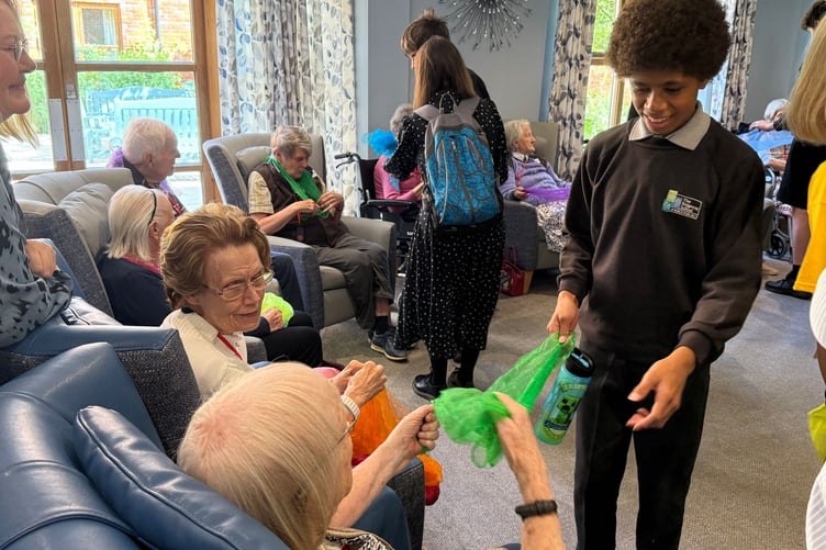 Elderly from Abbeyfield Wey Valley’s Hatch Mill Care Home enjoy the music session with pupils from Ridgeway School in Farnham.