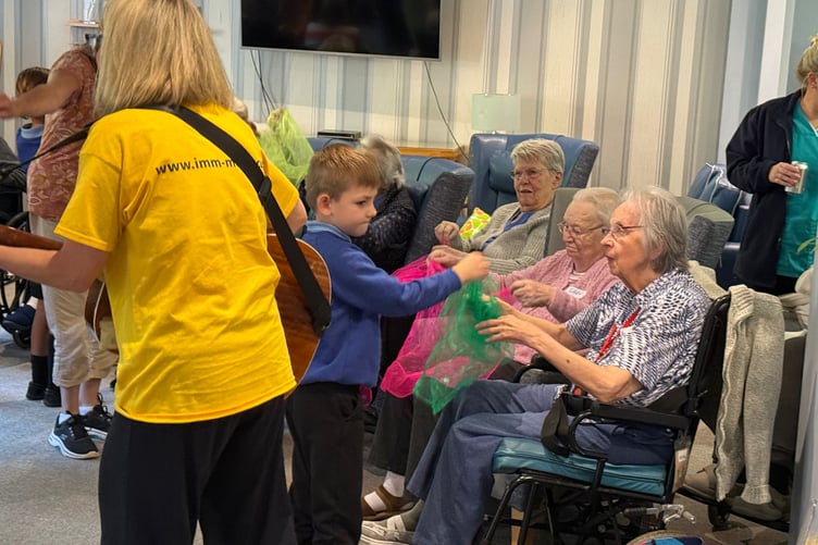 Pupils fro Ridgeway School interact with residents at Abbeyfield Wey Valley’s Hatch Mill Care Home.