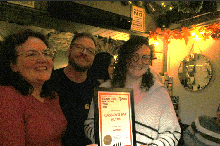 From left: CAMRA Hampshire county organiser Caroline Walsh presents its Hampshire Cider Pub of the Year award to Luke and Becca Cassidy of Cassidy's Bar in Alton, October 17th 2025.