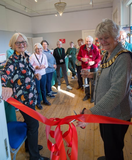 Town Mayor Jean Arrick cuts the ribbon at Cards for Good Causes pop-up shop at Haslemere Museum