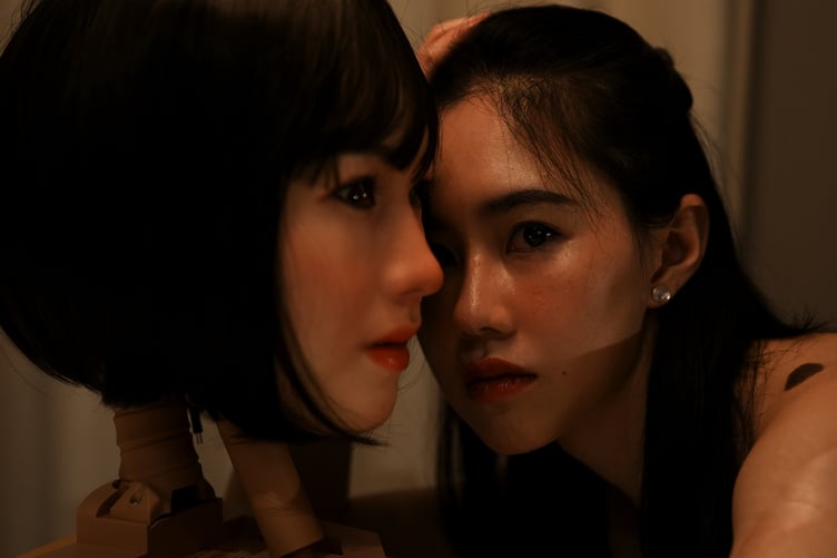 The artist Zhongjing Jiang with her robot doppelganger.