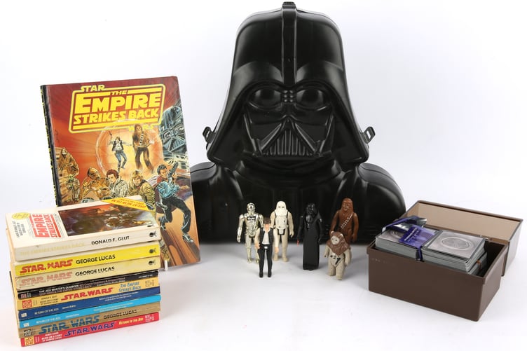 A collection of Star Wars figures and books.