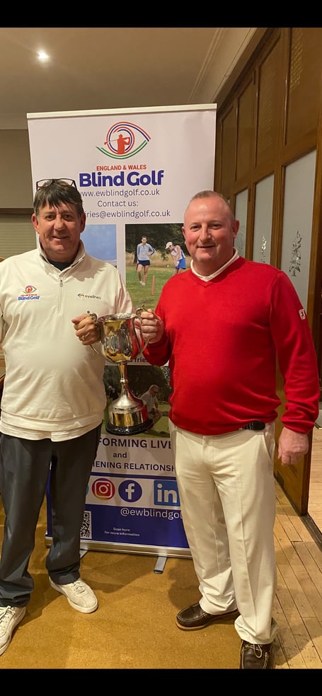 Farnham golfer Jason Bastable (right) holds the Cowdrey Cup with caddie Johnny Mason