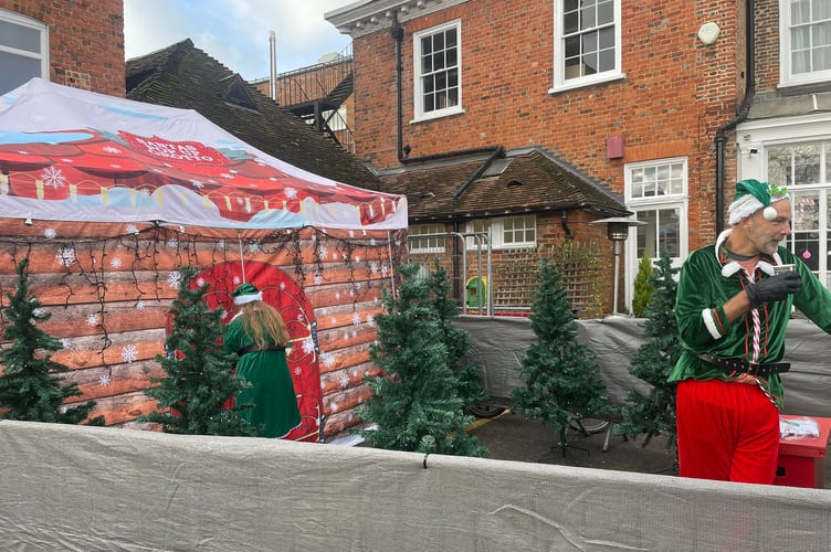An elf outside Santa's Grotto at Farnham Christmas Market 2025.