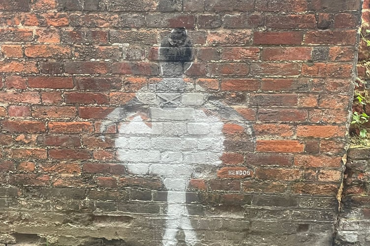 The graffiti reportedly by street artist Hendog appeared on a wall in Farnham.