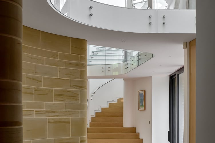 Downley House in South Downs National Park, near Petersfield, Hampshire. A house that was featured on Grand Designs has had to slash its price by a whopping £750,000 after failing to sell for 18 months.Downley House was listed for sale in July 2024 with a guide price of £5 million when owner Chris Taee decided it was time to sell up after 12 years in the property.Taee built the 7,374 sq ft oak-clad house from scratch, which boasts five bedrooms - three in the family wing and two guest bedrooms - five bathrooms and an oval-shaped central dining area with a 23ft high ceiling.The house was used by Kevin McCloud to host the Grand Designs House of the Year show there, whilst also being shortlisted for the RIBA House of the Year award.The property is built on 2.5 acres within a valley of South Downs National Park, near Petersfield, Hampshire.