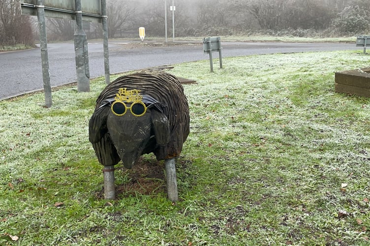 One of the wooden sheep in a celebratory mood at the A3013 roundabout near Fleet.