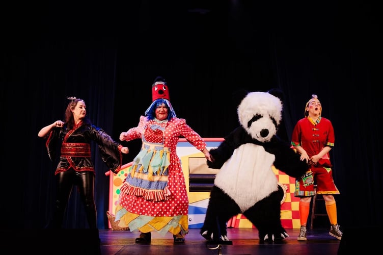 Lizzie Hales as Princess Jasmine, Tony Creasey as Widow Twankey, Naomi Robertson as Wishee Washee, and Kim Seymour as Nobby the Panda in Haslemere Thespians’ Aladdin. Credit: Front of House Photography