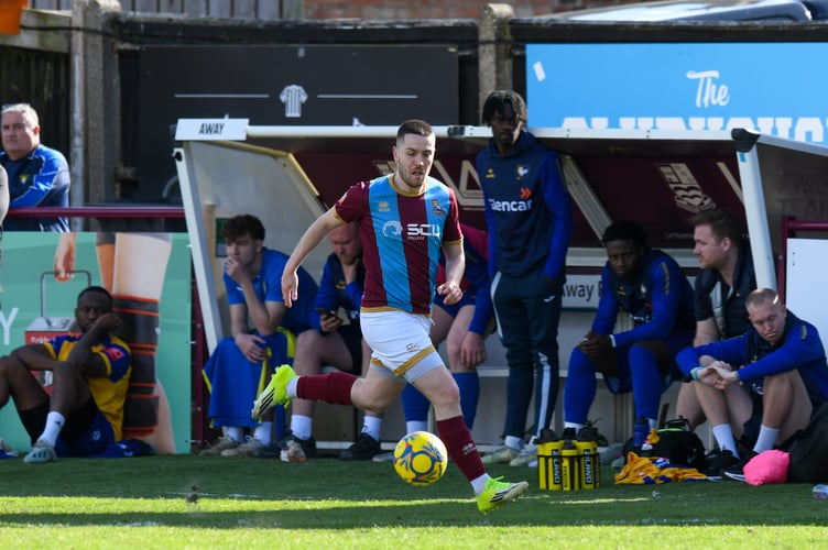Farnham Town's Darryl Sanders drives forward against Berkhamsted