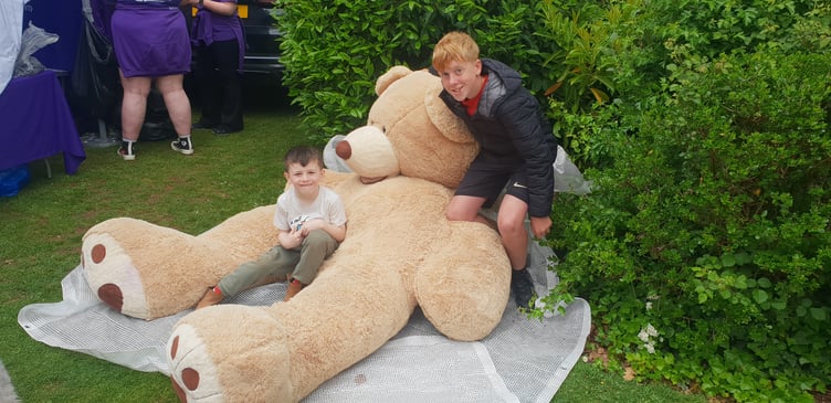 Ryleigh Priddle (right) won this giant teddy bear in a Wellington Majorettes' tombola and gifted it to Wellesley Park Primary School pupil Finley Bates (left).