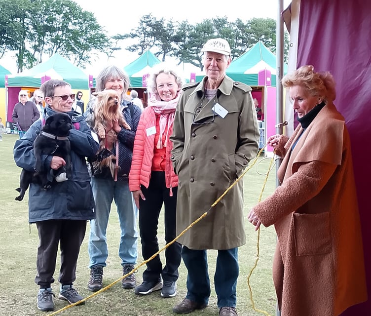 Watchet Mayor Cllr Loretta Whetlor opens the town's dog show with judges Dr John Gage and Karen Minto, and two participants.