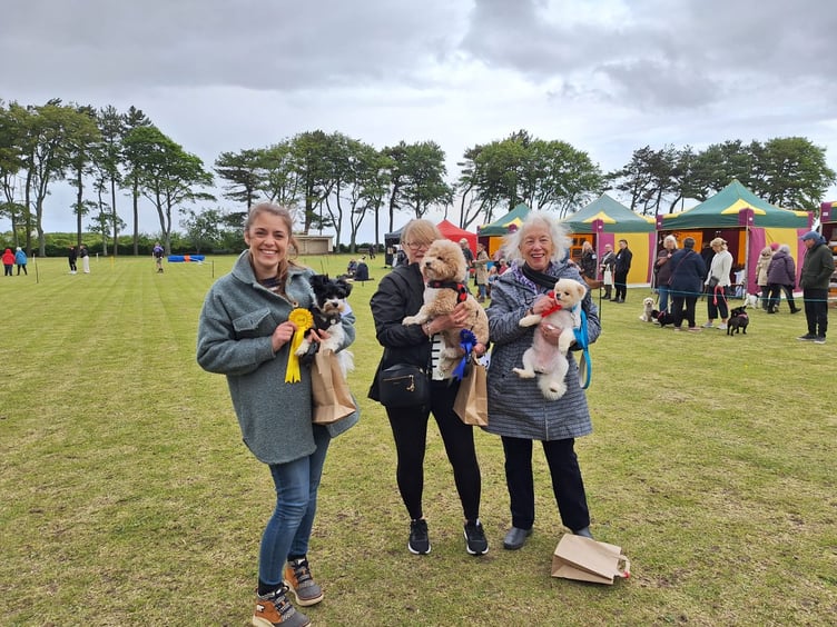 Happy owners and their dogs with rosettes won at Sunday's first dog show on Watchet War Memorial Recreation Ground.