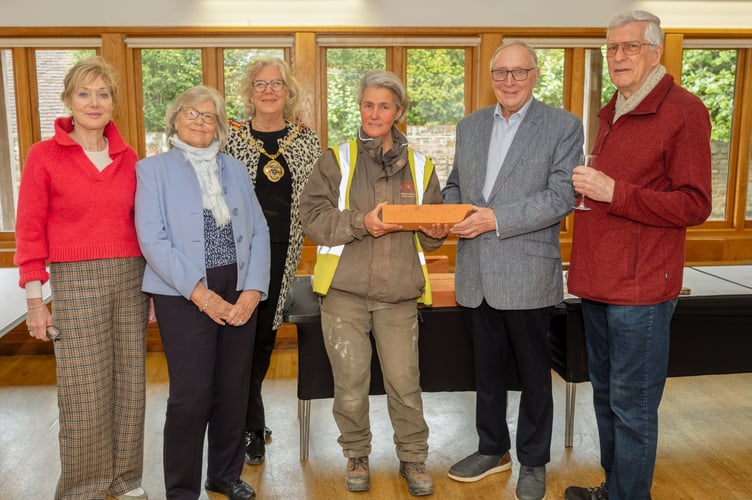 At the reception celebrating the restoration project are, pictured from left, Cllr Kika Mirylees; Ella Cattell, trustee of the Farnham Public Art Trust; Cllr Penny Rivers; Emma Simpson of Simpsons Brickwork Conservation; Richard Hunt, chair of The Farnham Society, and John Neale, chair of the Farnham Public Art Trust.