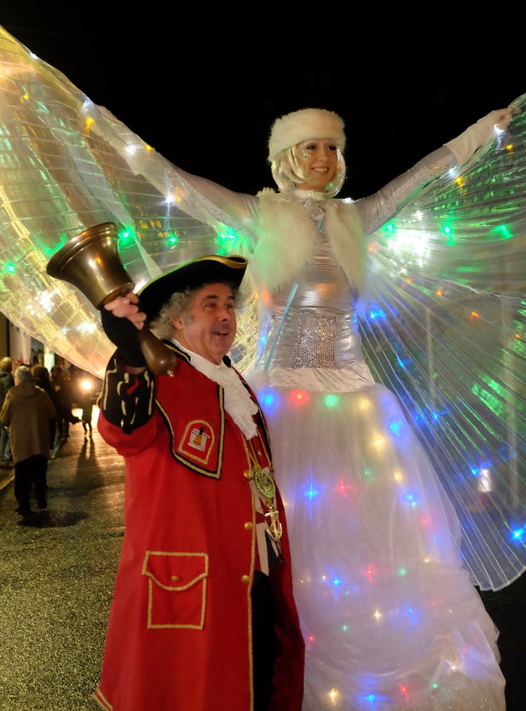 Wearing his red robes for Watchet's late night Christmas extravaganzas is town crier David Milton with a 'Wish Fairy'.