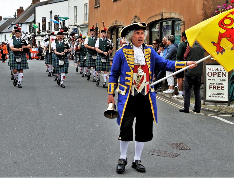 Bideford Youth Pipe Band are led through Watchet by town crier David Milton is his blue outfit.