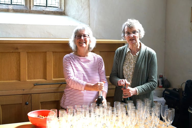 Marion Moncrieff and Wendy Cook preparing the 'fizz' without which no Timberscombe St Petrock's Church Choral Evensong would be complete.