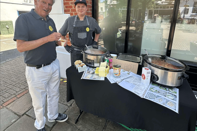 Gordon Pope from the Alton Foodbank tastes 15-year-old chef Dexter Olejarka's cooking at an open day to mark the foodbank's 15th birthday, June 13th 2026.