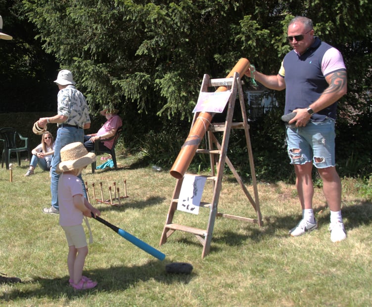 Lucy Locket tries her hand at Splat The Rat in Sampford Brett village fete. PHOTO: George Ody.