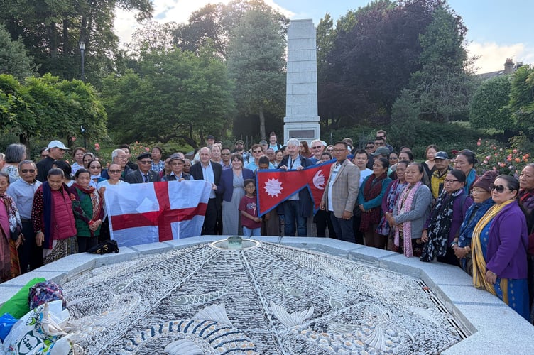 Dozens of members of the public gather to show their support to the Nepalese community