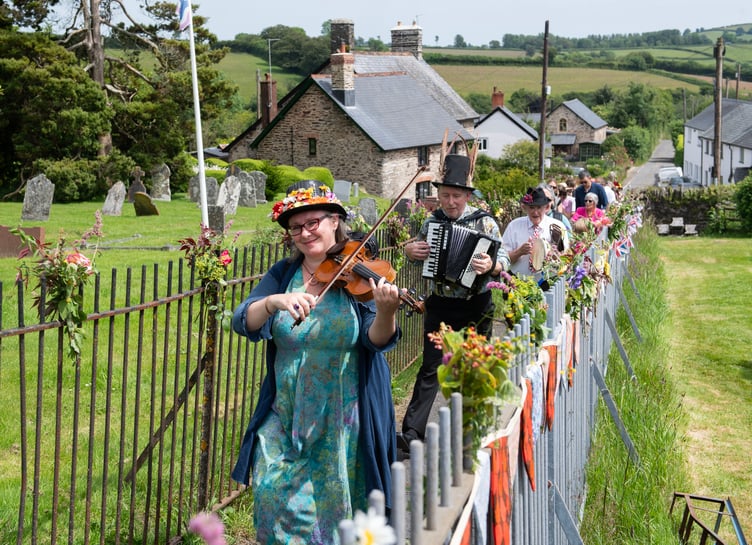Musicians lead the way as villagers process to the Millennium Green in Brompton Regis to celebrate 25 years of community ownership. PHOTO: Dale Cherry.